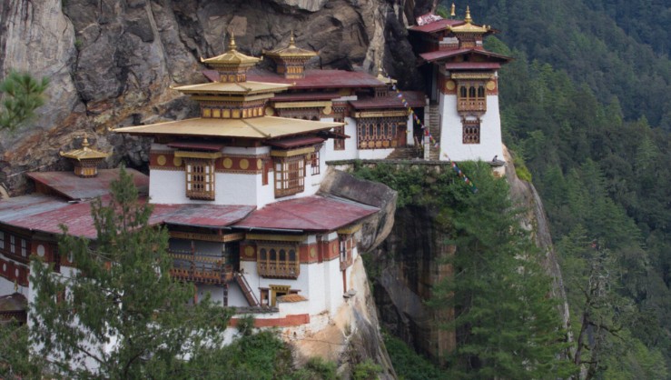 Paro Taktsang Tiger's Nest Monastery perched on a sheer cliff face surrounded by pine forest in Bhutan